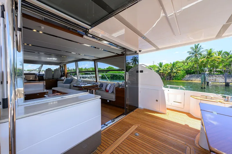 Slide: The Image of Luxurious 2020 Princess F70 yacht interior with open deck, elegant seating, and scenic waterfront view. - 72