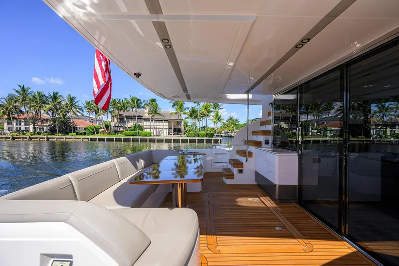 Slide: The Image of Luxurious 2020 Princess F70 yacht deck with seating, table, and waterfront view. - 74