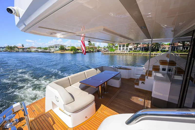 Slide: The Image of Luxurious 2020 Princess F70 yacht deck with elegant seating and scenic waterfront view. - 75