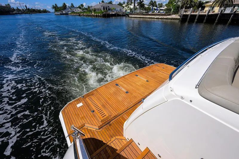 Slide: The Image of Luxury yacht Princess F70 cruising on a sunny day, showcasing elegant teak deck. - 79