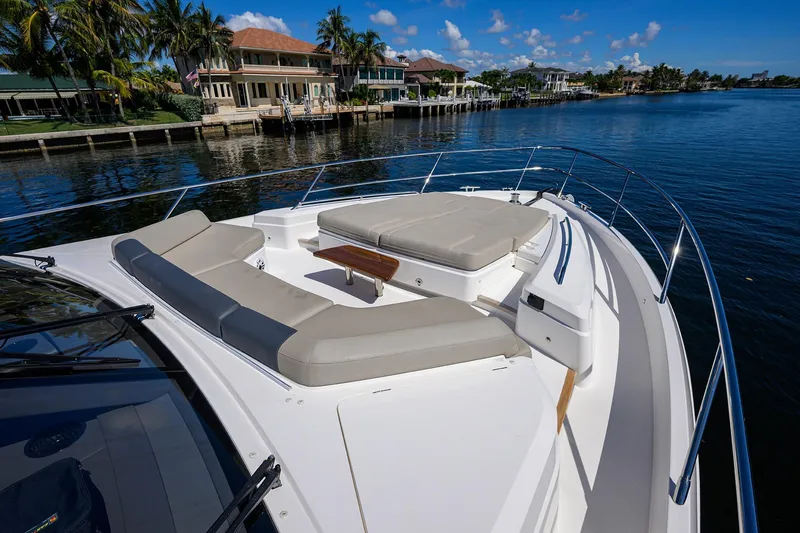 Slide: The Image of Luxurious 2020 Princess F70 yacht with spacious deck seating, docked by waterfront homes. - 82