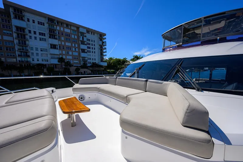 Slide: The Image of Luxurious 2020 Princess F70 yacht deck with seating and table, near waterfront buildings. - 86