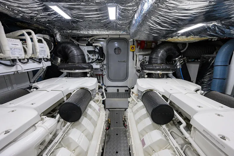 Slide: The Image of Engine room of a 2020 Princess F70 yacht, featuring dual engines and advanced ventilation. - 95
