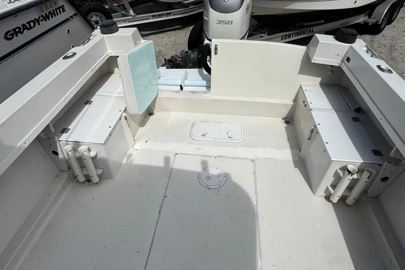 Slide: The Image of 1984 Grady-White Offshore 24 boat interior with storage compartments and rod holders. - 10