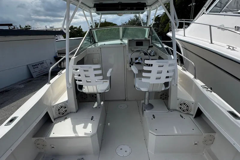 Slide: The Image of 1984 Grady-White Offshore 24 boat interior with dual white captain chairs and steering console. - 11