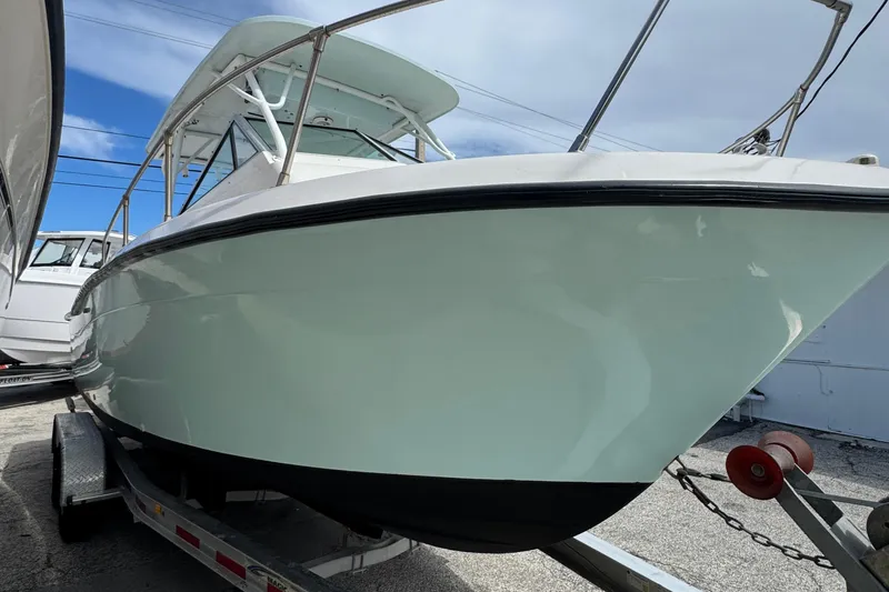 Slide: The Image of 1984 Grady-White Offshore 24 boat on trailer, side view under clear sky. - 2