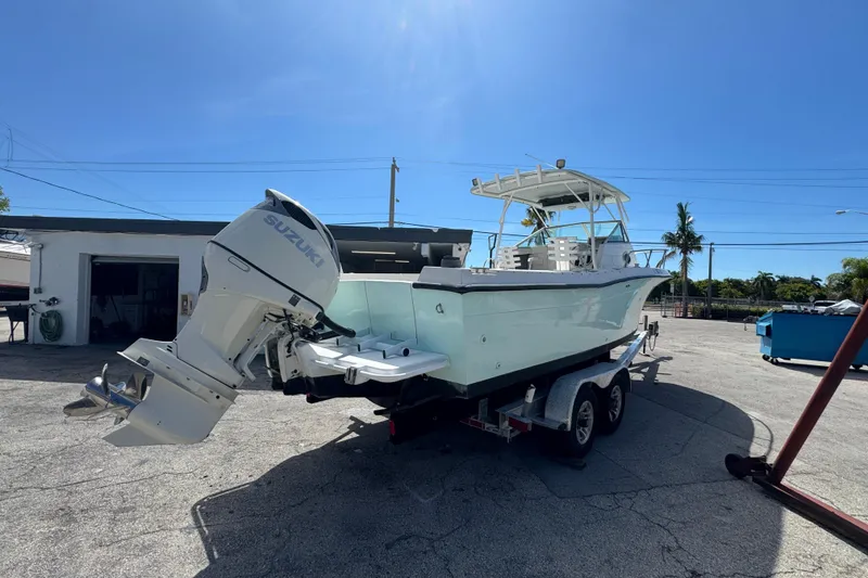 Slide: The Image of 1984 Grady-White Offshore 24 boat with Suzuki outboard motor on trailer. - 4