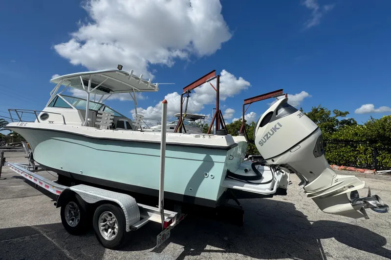 Slide: The Image of 1984 Grady-White Offshore 24 boat with Suzuki outboard motor on a trailer. - 5