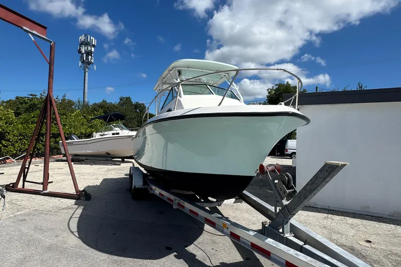 Slide: The Image of 1984 Grady-White Offshore 24 boat on trailer under clear blue sky. - 6