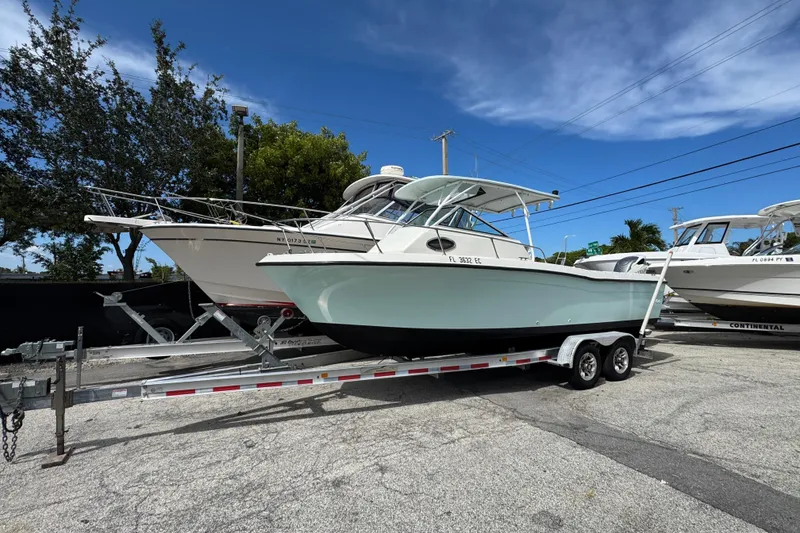 Slide: The Image of 1984 Grady-White Offshore 24 boat on trailer under clear blue sky. - 7