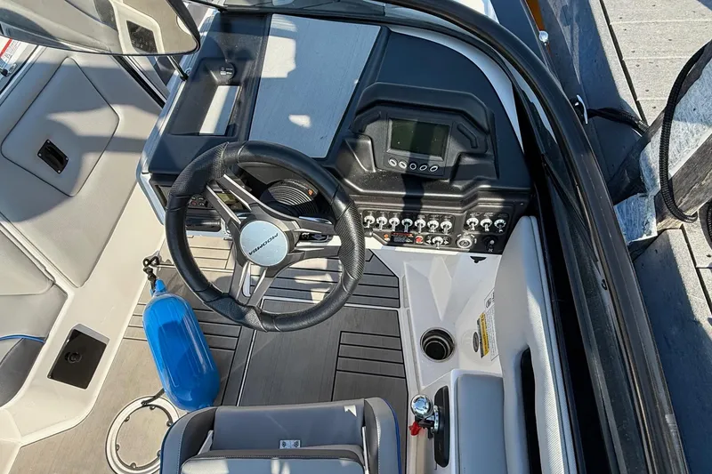 Slide: The Image of 2019 Moomba Helix boat dashboard with steering wheel and control panel. - 6