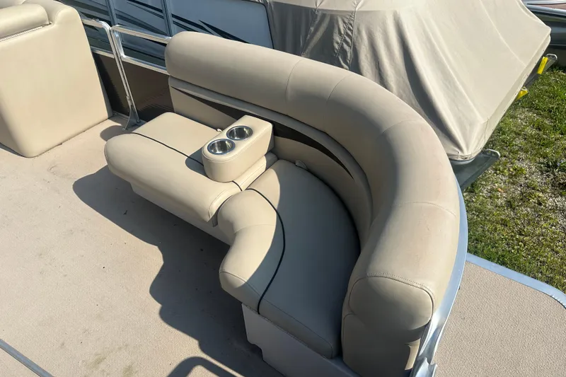Slide: The Image of Luxurious seating on a 2011 Harris Cruiser 200 pontoon boat with cup holders. - 2