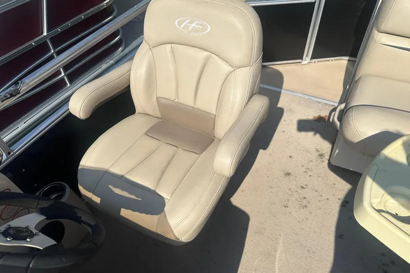 Slide: The Image of Beige captain's chair on 2011 Harris Cruiser 200 boat deck. - 6