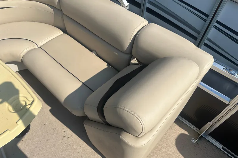 Slide: The Image of Beige seating on 2011 Harris Cruiser 200 pontoon boat, with cup holder and railing. - 8