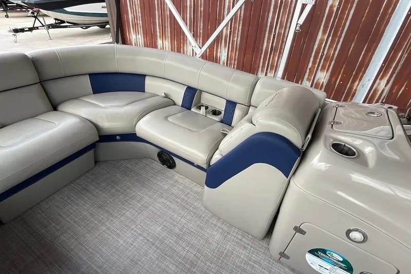 Slide: The Image of Luxurious seating on a 2020 South Bay 523 pontoon boat, featuring beige and blue upholstery. - 10