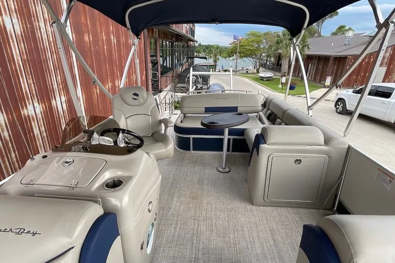 Slide: The Image of 2020 South Bay 523 pontoon boat interior with seating and steering console. - 11