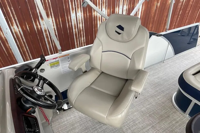 Slide: The Image of Captain's chair and steering wheel on 2020 South Bay 523 pontoon boat. - 12