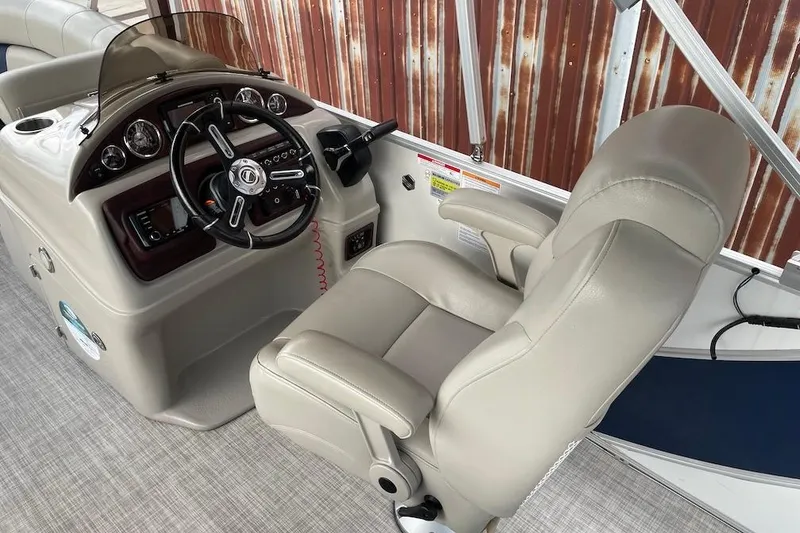 Slide: The Image of Captain's chair and helm of 2020 South Bay 523 boat, featuring modern controls and steering wheel. - 7