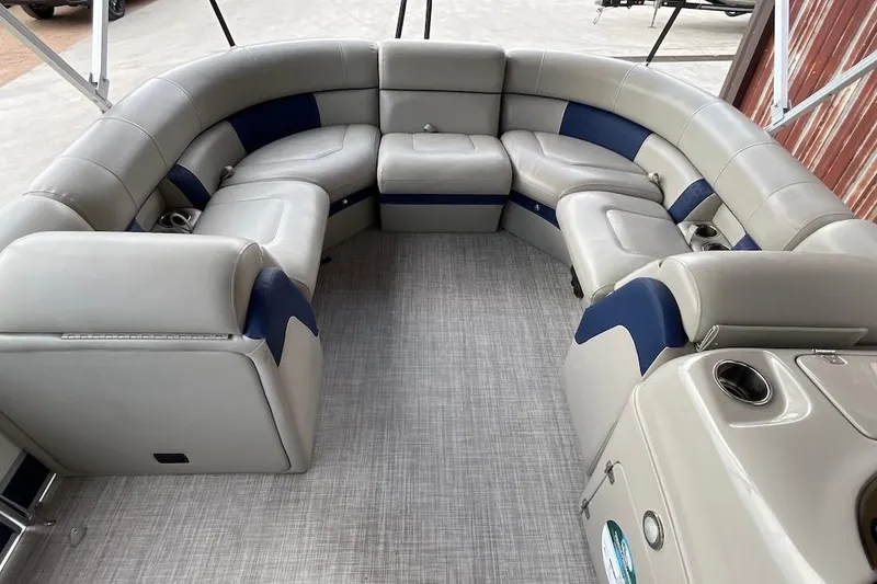 Slide: The Image of Luxurious seating on 2020 South Bay 523 pontoon boat, featuring plush gray and blue upholstery. - 8
