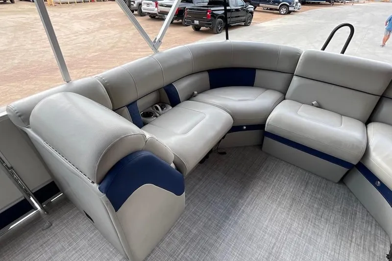 Slide: The Image of Luxurious seating on a 2020 South Bay 523 pontoon boat, featuring plush gray and blue upholstery. - 9