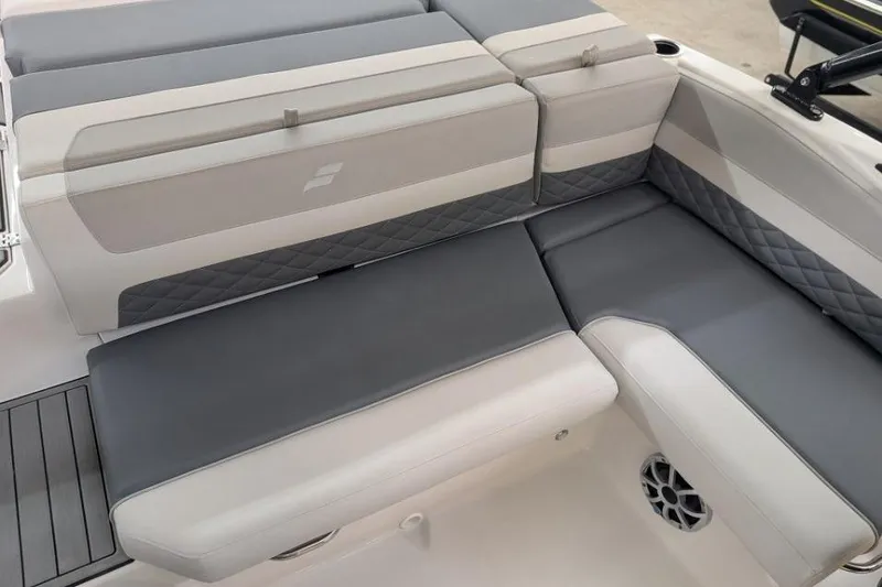 Slide: The Image of 2025 Starcraft SVX 210 IO boat interior with gray and white cushioned seating. - 10