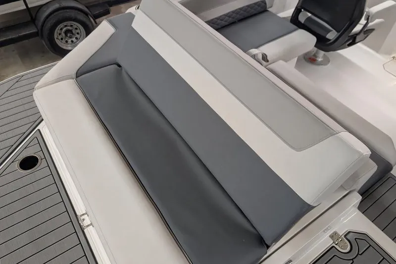 Slide: The Image of 2025 Starcraft SVX 210 IO boat interior with gray and white seating. - 11