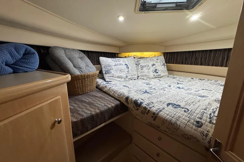 Slide: The Image of Cozy cabin interior of 1998 Carver 356 Aft Cabin with nautical-themed bedding. - 10