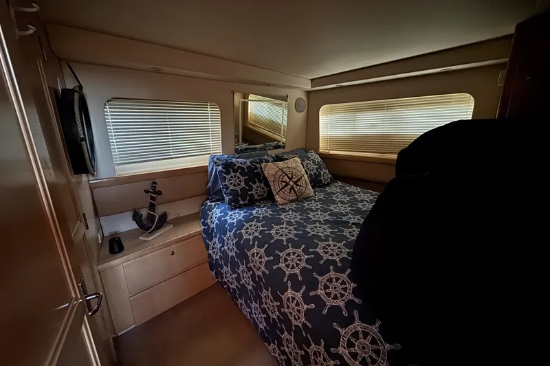 Slide: The Image of Cozy bedroom in 1998 Carver 356 Aft Cabin with nautical-themed bedding and decor. - 14