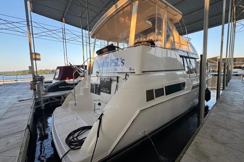 Slide: The Image of 1998 Carver 356 Aft Cabin yacht docked, for sale, under covered marina. - 2