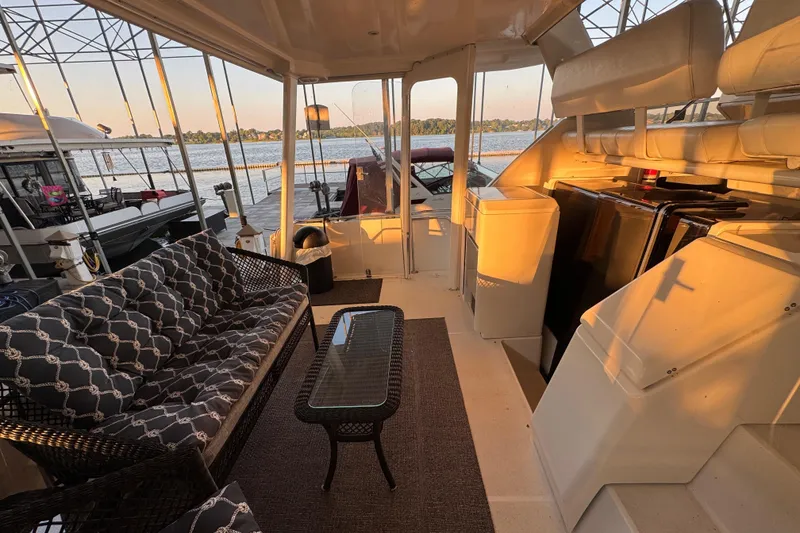 Slide: The Image of 1998 Carver 356 Aft Cabin interior with seating, table, and lake view. - 5