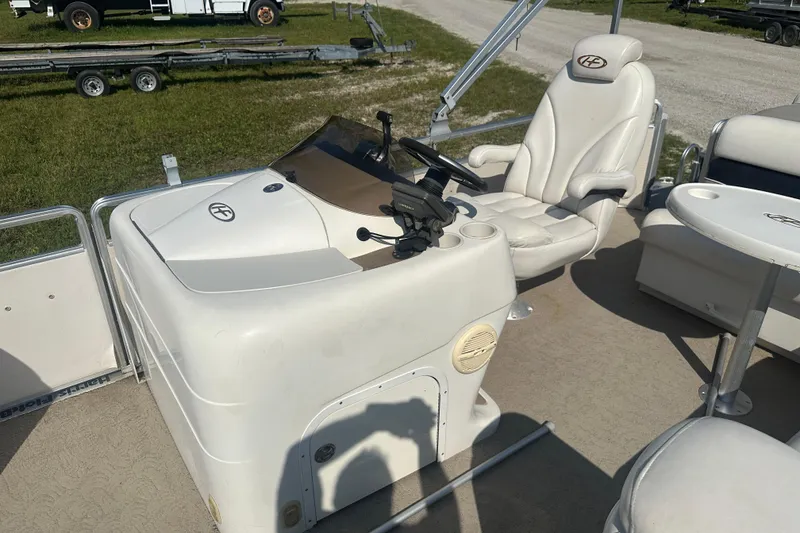 Slide: The Image of 2005 Harris Classic 260 boat interior with captain's chair and control console. - 12