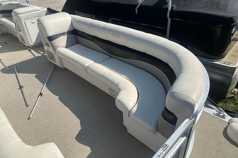 Slide: The Image of 2005 Harris Classic 260 boat with curved white seating on deck. - 4