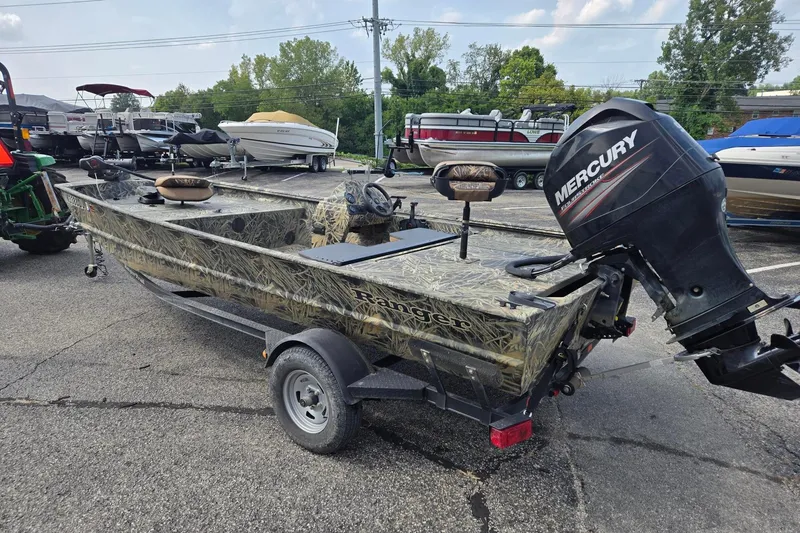 Slide: The Image of 2014 Ranger 1862 MPV boat with Mercury outboard motor in a parking lot. - 2