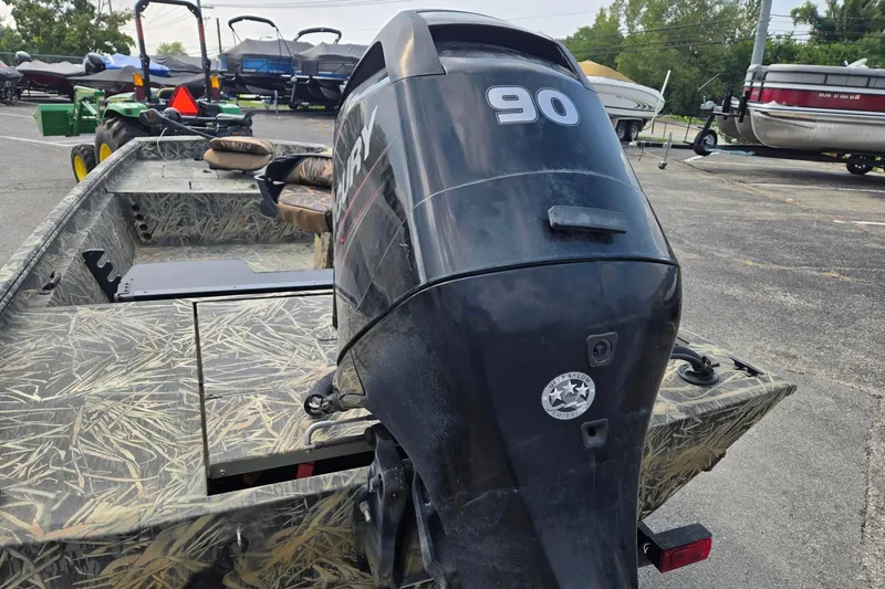 Slide: The Image of 2014 Ranger 1862 MPV boat with Mercury 90 engine in a parking lot. - 3