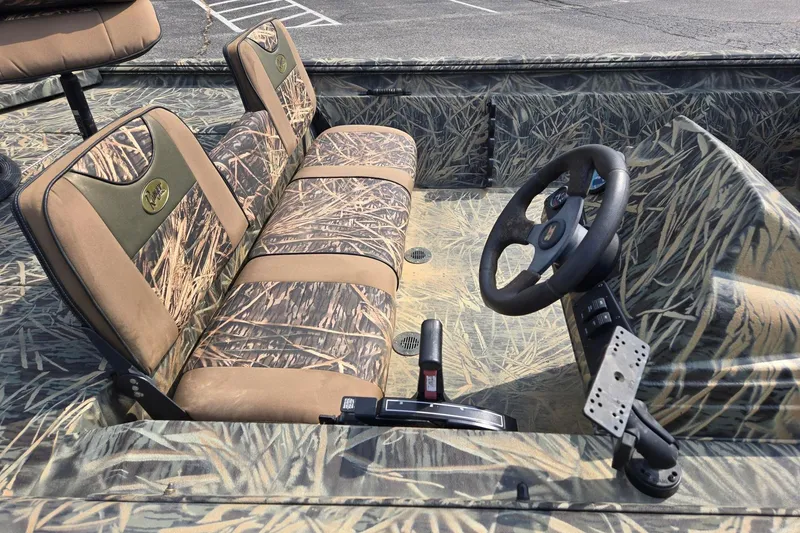 Slide: The Image of 2014 Ranger 1862 MPV boat interior with camouflage seats and steering wheel. - 9
