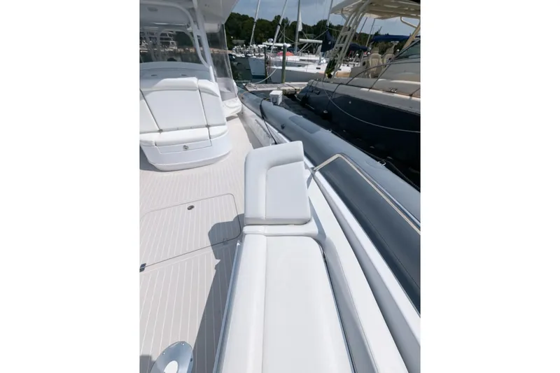 Slide: The Image of 2015 Yellowfin RIB boat with sleek white seating and deck, docked at a marina. - 10