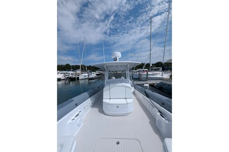 Slide: The Image of 2015 Yellowfin RIB boat docked at marina under blue sky. - 13