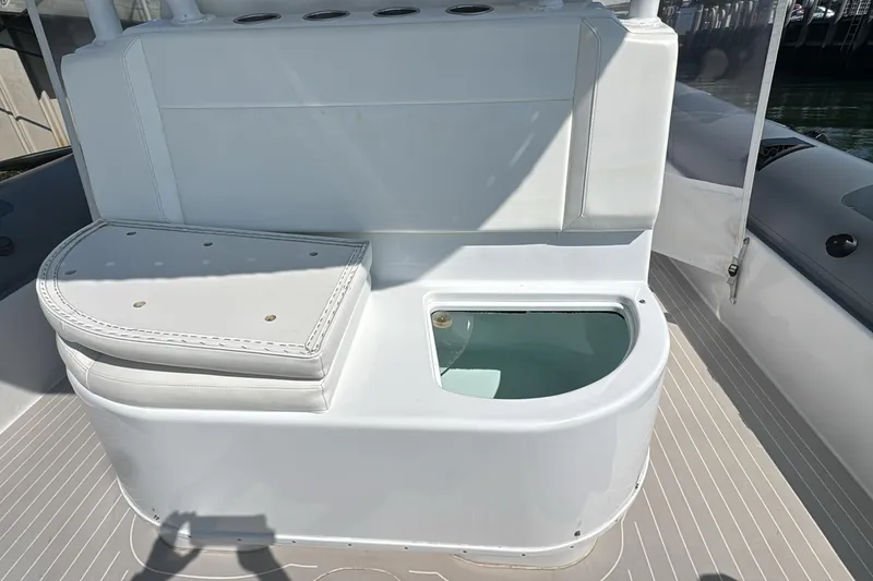 Slide: The Image of 2015 Yellowfin RIB boat interior with cushioned seating and storage compartment. - 15