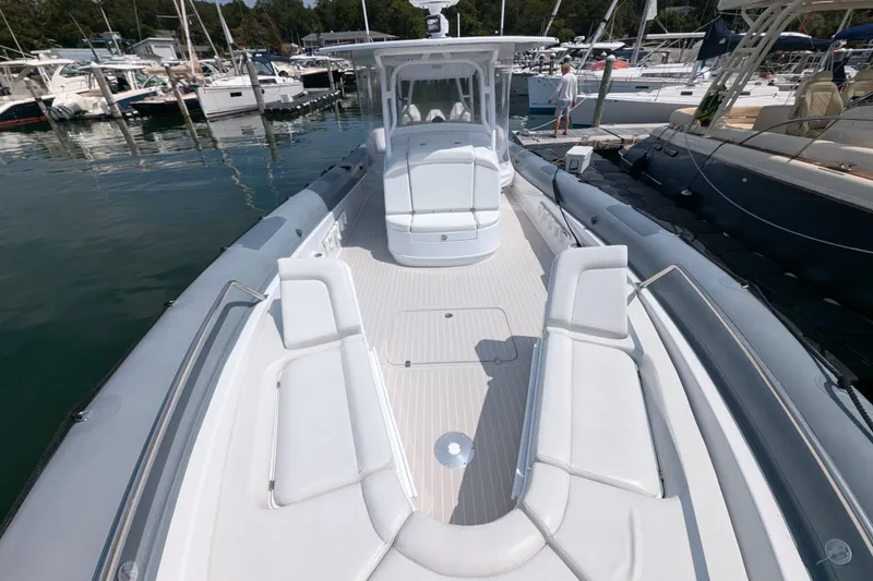 Slide: The Image of 2015 Yellowfin RIB boat with spacious deck, docked at marina. - 7