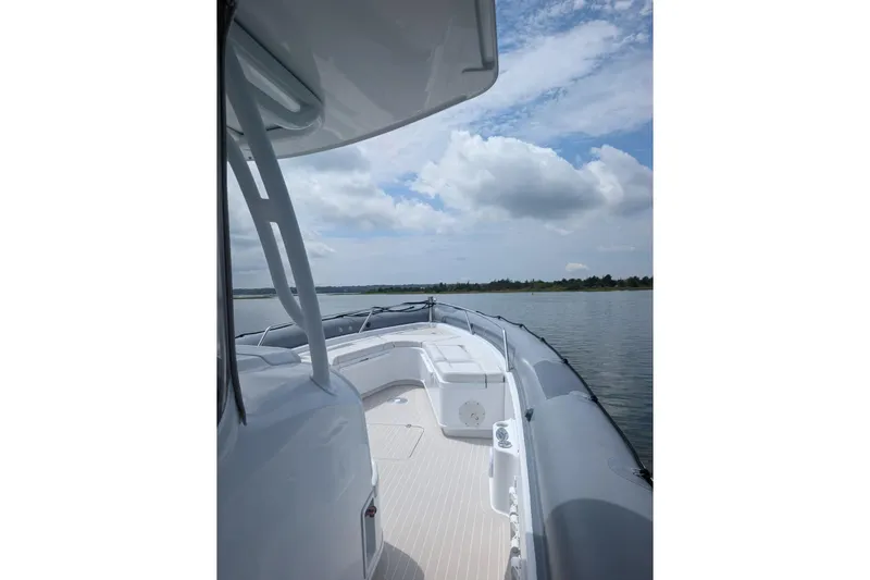 Slide: The Image of 2015 Yellowfin RIB boat on calm water under a partly cloudy sky. - 9