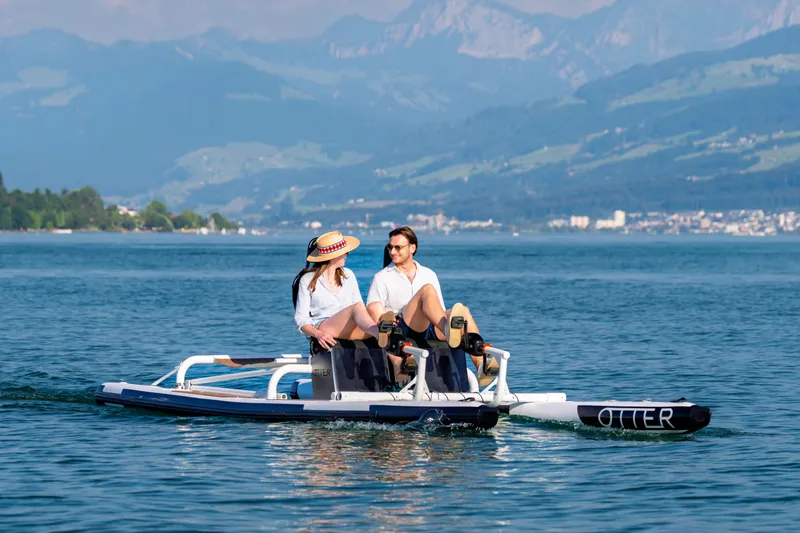 Slide: The Image of Couple enjoying a ride on the 2025 OTTER Otter Bike on a scenic lake. - 3