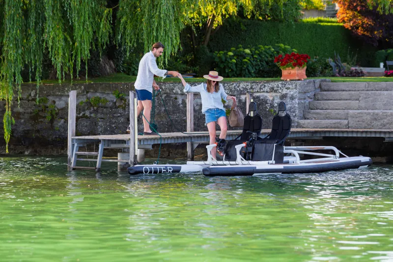 Slide: The Image of Couple enjoying a 2025 OTTER Otter Bike on a serene lake. - 4