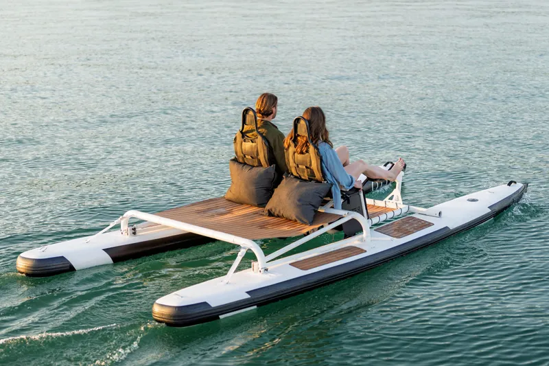 Slide: The Image of Two people riding a 2025 OTTER Otter Bike on water. - 6