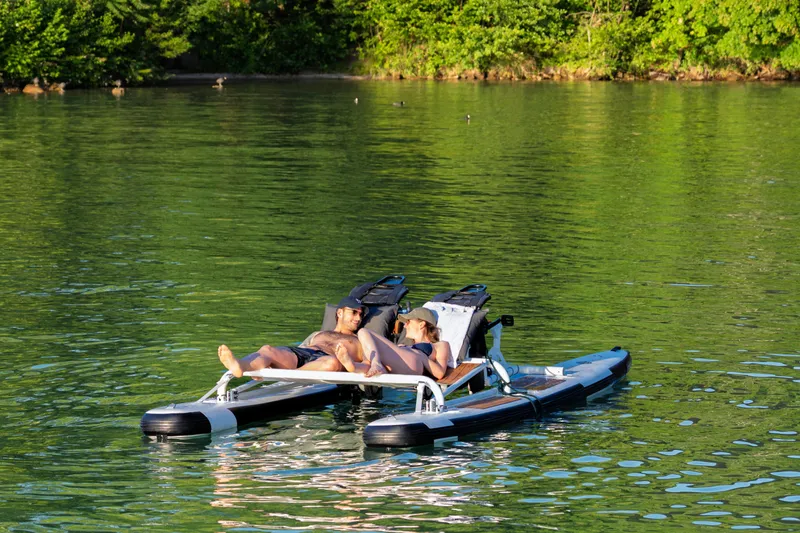 Slide: The Image of Couple relaxing on 2025 OTTER Otter Bike on a serene lake. - 7