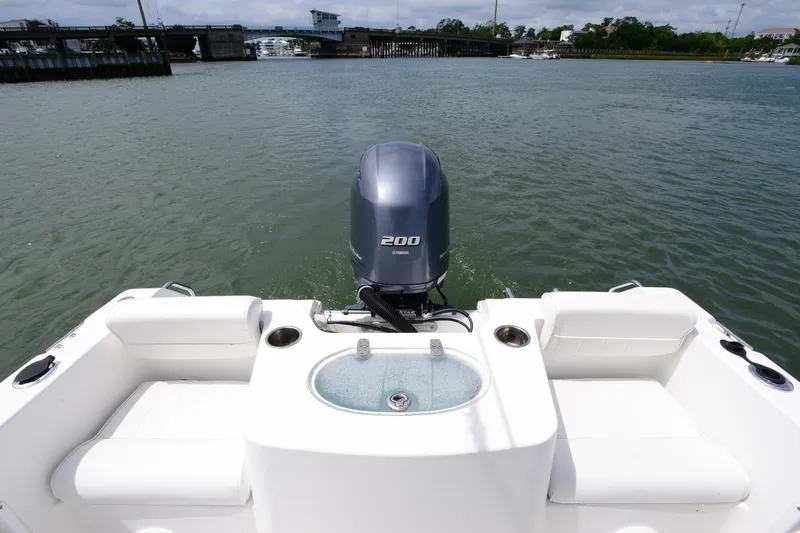 Slide: The Image of 2015 Sea Hunt Triton 210 boat with Yamaha 200 engine on calm water. - 15