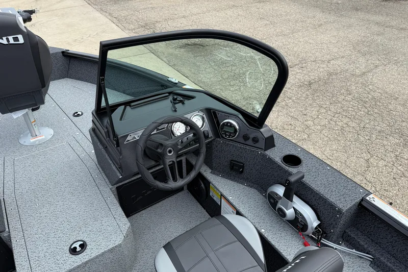 Slide: The Image of 2026 Lund 1800 Explorer Sport boat interior with steering wheel and control panel. - 15