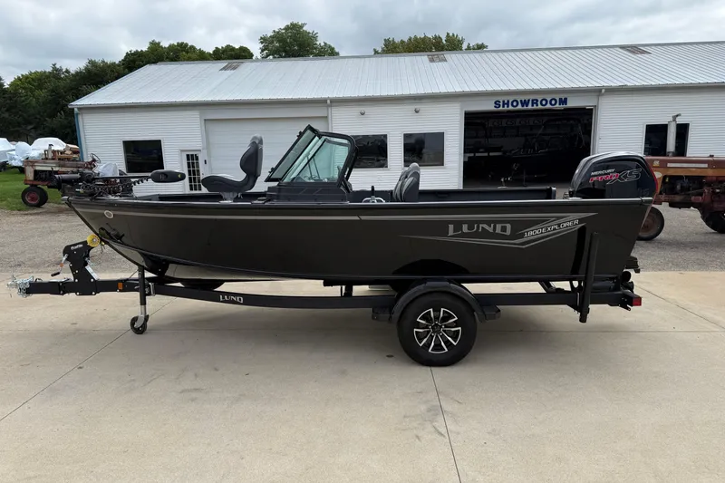 Slide: The Image of 2026 Lund 1800 Explorer Sport boat on trailer outside showroom. - 4