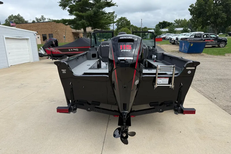 Slide: The Image of 2026 Lund 1800 Explorer Sport boat with Mercury 115 Pro engine, parked outdoors. - 6