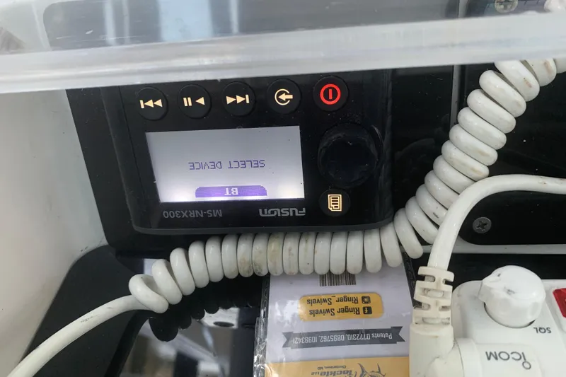 Slide: The Image of Control panel of a 2008 Invincible 36 CC boat with coiled cables and display. - 16