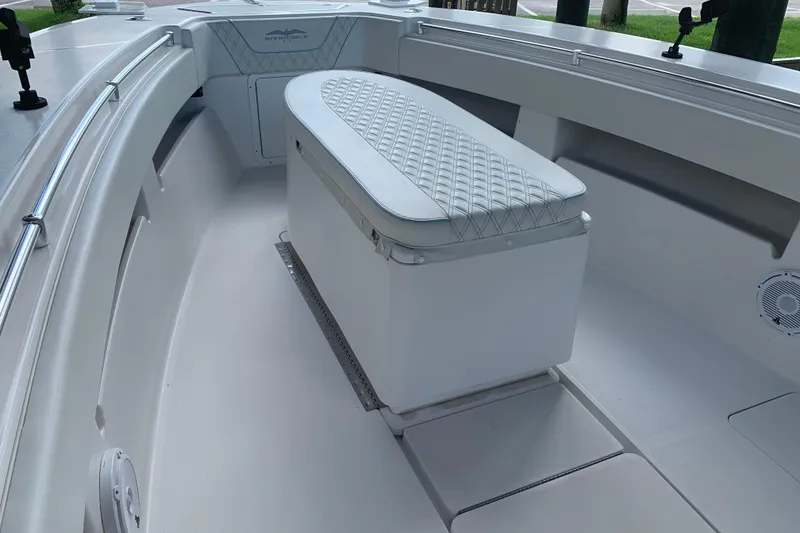 Slide: The Image of 2008 Invincible 36 CC boat interior with cushioned seating and storage. - 17
